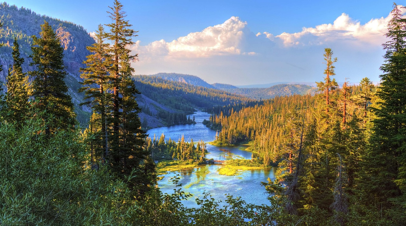 Majestic mountains surround a winding river, highlighting the beauty of nature in a serene landscape.