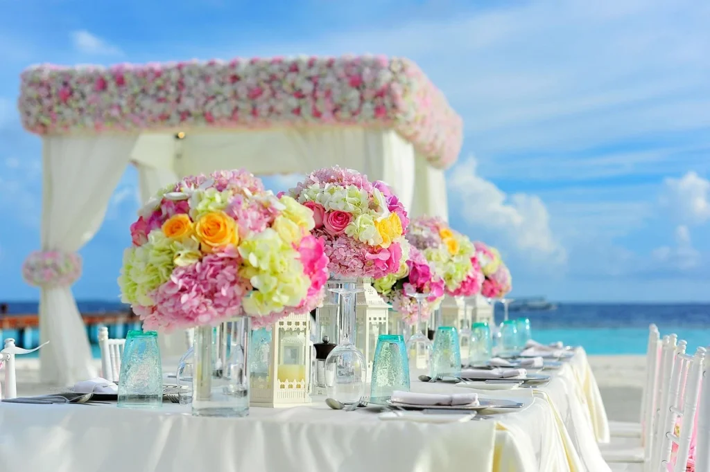 A beautifully set table featuring a centerpiece of white and pink flowers, enhancing the decor with a touch of color.