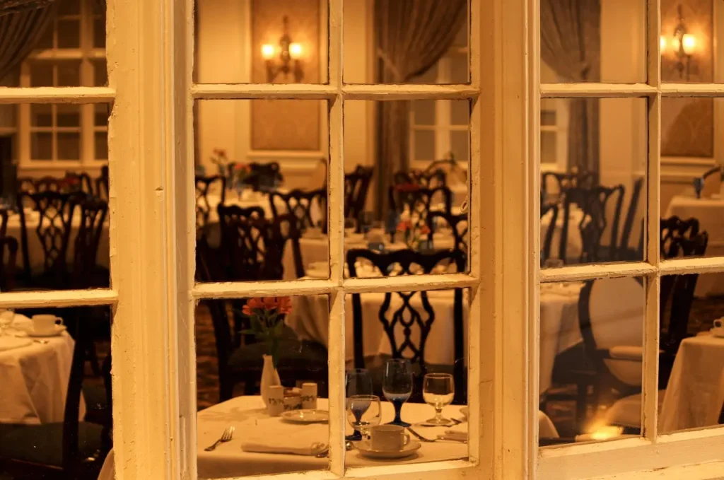A window featuring a table and chairs set up for dining or relaxation.
